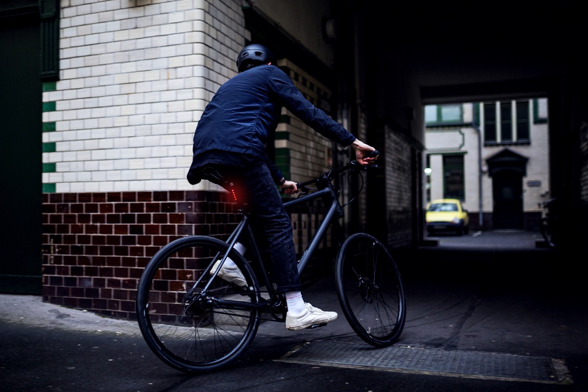 man riding a hybrid bike on city streets