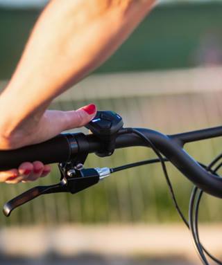 a person holding a bicycle handlebar