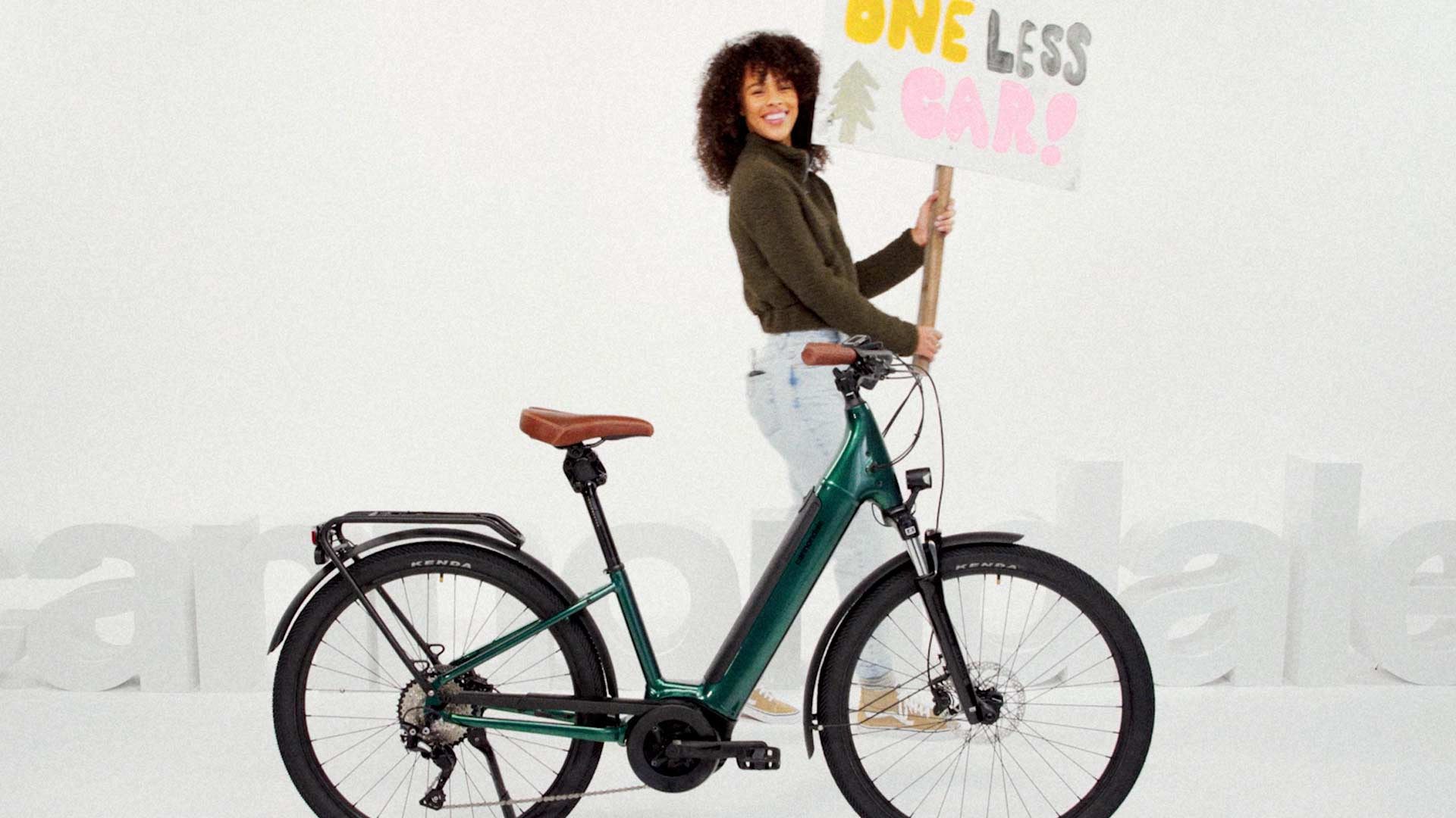 Fleur East holding a bicycle