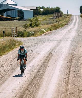 a person riding a bike on a dirt road
