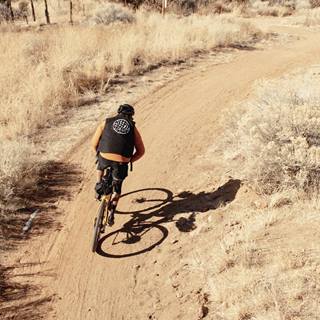 a person riding a bike on a dirt road